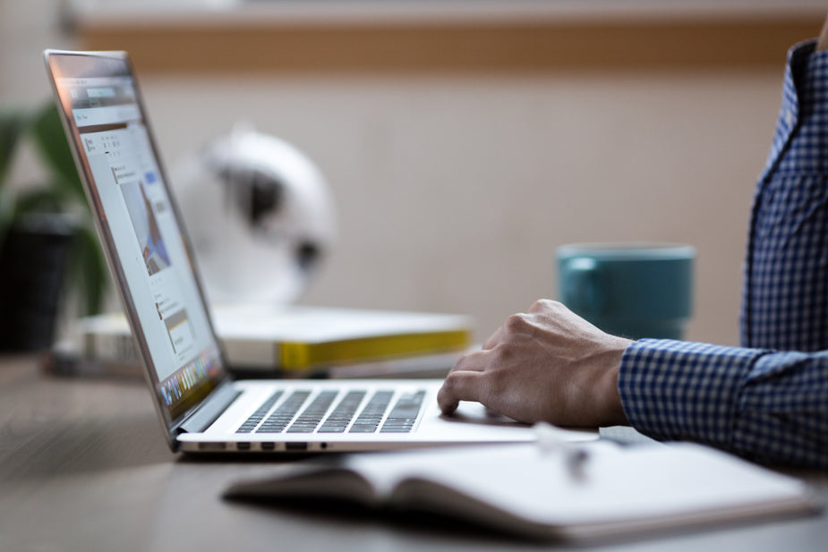 Laptop on desk for email follow-up workflow planning